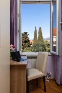 a laptop sitting on a desk in front of a window at Villa Falkoni II in Dubrovnik