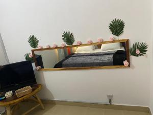 a bedroom with a bed and a desk with a computer at Globe-trotter vision A in Cotonou
