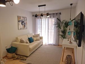 a living room with a couch and a window at APARTAMENTO CORAL in Guía de Isora