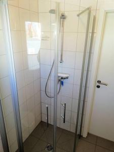 a shower in a bathroom with a glass door at Apartement Meerblick in Wunstorf