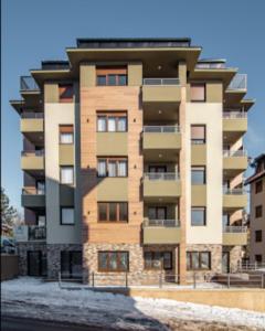a tall apartment building in front of a street at apartment zlatibor in Zlatibor