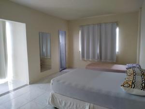 a bedroom with a large bed and a mirror at RECANTO BUSCAPE in Alto Caparao