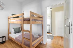 a bedroom with two bunk beds in a room at Lion Apartments - London in Sopot