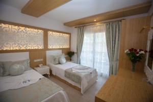 Postel nebo postele na pokoji v ubytování Hotel Aysima