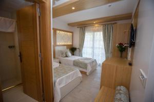 Postel nebo postele na pokoji v ubytování Hotel Aysima