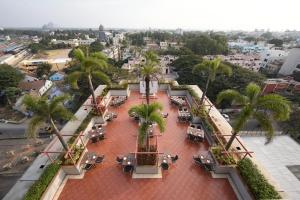 an overhead view of a courtyard with palm trees and tables at RATHNA RESIDENCY in Coimbatore