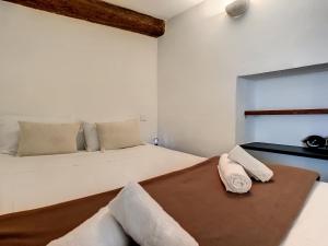 a bedroom with a large white bed with two pillows at Nestor&Jeeves - ZEN - Central - Very close beaches in Nice
