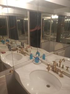 a bathroom with two sinks and a large mirror at La Generosa in San Carlos de Bariloche +43 photos