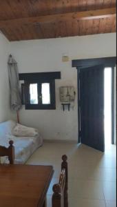 a bedroom with a bed and a window and a door at Lo raconet 2 in L'Ampolla