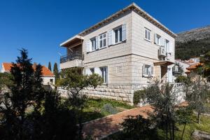 a large white house on the side of a hill at Villa Falkoni II in Dubrovnik
