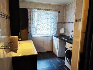 a small kitchen with a sink and a washing machine at Visit Undredal in Undredal +35 photos