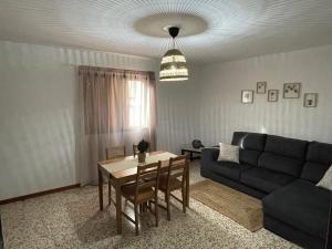 a living room with a table and a couch at Casa Candelaria in La Laguna