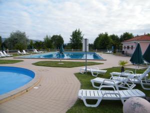a pool with chaise lounge chairs and a swimming pool at INATEL Cerveira Hotel in Vila Nova de Cerveira