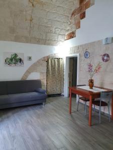 a living room with a table and a couch at Lungomare Modugno in Polignano a Mare