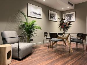 a waiting room with a table and chairs at AZ Hotel San Valero in Zaragoza