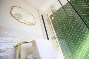 a bathroom with a towel rack and a mirror at Beautiful Luxe Victorian Townhouse - 5 mins walk from Warwick Castle & town in Warwick