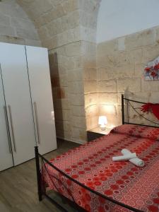a bedroom with a bed in a stone wall at Lungomare Modugno in Polignano a Mare