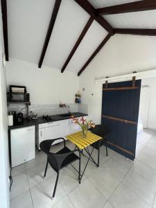 a kitchen with a table and chairs in a room at Prune Café in Deshaies