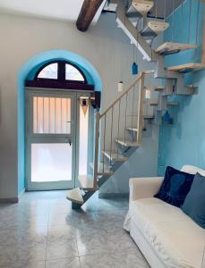 a living room with a staircase and a couch at Appartamento SoloSoleMare in Portovenere