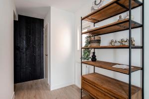 a room with wooden shelves and a door at Marley’s Beachhouse - Luxury Guest Room with balcony in Zandvoort