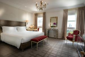 a bedroom with a large bed and a chandelier at Alvear Palace Hotel - Leading Hotels of the World in Buenos Aires