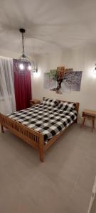 a large bed in a room with a red curtain at University Apartment in Baia Mare