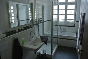 a bathroom with a sink and a shower and a tub at Haus Drei Könige in Balve