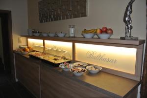 a buffet with bowls of food on a counter at Haus Drei Könige in Balve