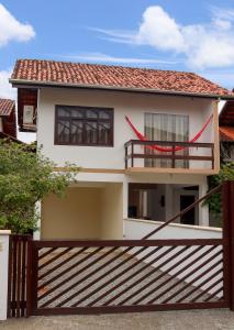 a house with a fence in front of it at Apê Jabuticabeira in Pomerode
