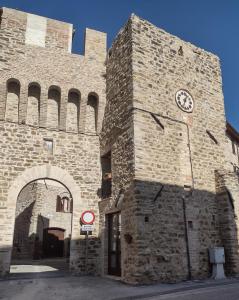 a building with a clock on the side of it at La Castellana in Spina