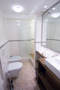 a bathroom with a toilet and a sink and a shower at Venice Rialto Bridge Apartment in Venice