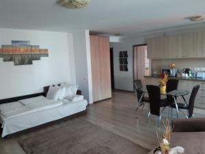 a living room with a white couch and a table at Apartament Marcel - Coresi Mall in Braşov