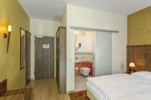 Postel nebo postele na pokoji v ubytování Hotel l'adresse garni