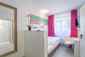 Postel nebo postele na pokoji v ubytování Hotel l'adresse garni