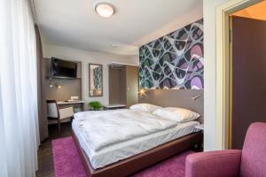 Postel nebo postele na pokoji v ubytování Hotel l'adresse garni