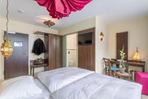 Postel nebo postele na pokoji v ubytování Hotel l'adresse garni