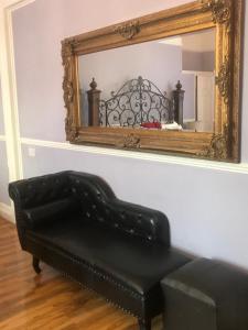 a black couch sitting on top of a wooden table at Kempfield House in Brighton & Hove