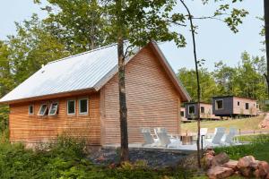 a house with chairs in front of it at Wild Rice Retreat in Bayfield
