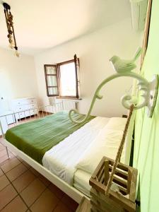 a bedroom with a bed in a room with a window at Podere al Fico B&B in Collemezzano