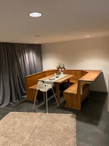 a dining room with a wooden table and a bench at Gästezimmer am Waldrand in Leimbach