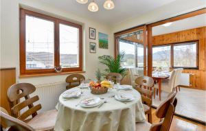 a dining room with a table with a bowl of fruit on it at Lovely Home In Jastrebarsko With Sauna in Jastrebarsko