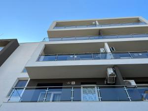 an apartment building with a car on the balcony at Tranzzzit Airport Apartment in Otopeni