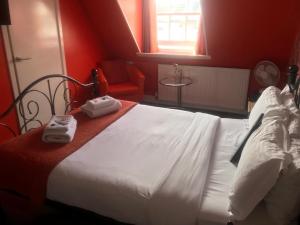 a hotel room with a bed and a desk at Kempfield House in Brighton & Hove