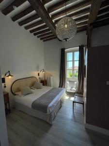 a bedroom with a large bed and a large window at La Solenzara Hôtel in Sari Solenzara