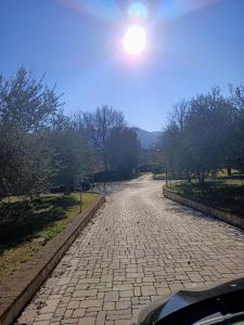 a cobblestone street with the sun in the sky at RossoMattone CountryHouse in Sulmona