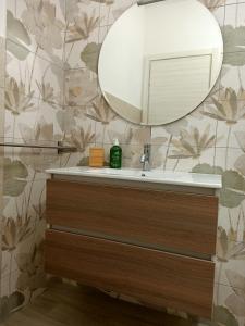 a bathroom with a sink and a mirror at RossoMattone CountryHouse in Sulmona