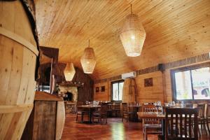 a dining room with tables and chairs and lights at Hotel Valle 13 Ruta del Vino in Valle de Guadalupe +36 photos