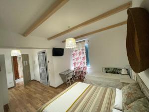 a bedroom with two beds and a desk in it at Torremana in Càbras