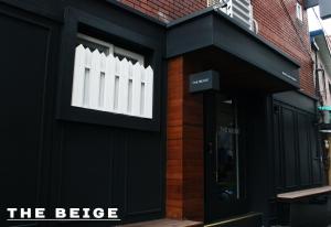 a black building with a window on the side of it at Hostel Beige 2nd in Seoul