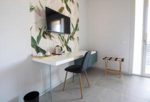 TV a/nebo společenská místnost v ubytování B&B Fior di Magnolia
